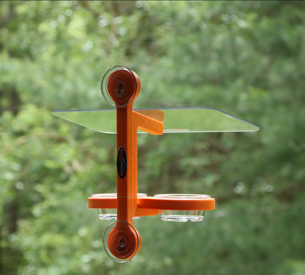 Orange oriole feeder made of recycled plastic is window mounted with suction cups. Two removable plastic dishes. 