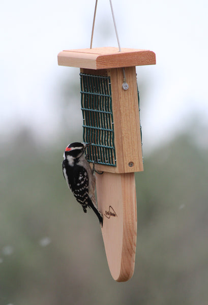 cedar suet feeder with a woodpecker eating
