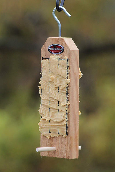 peanut butter on cedar feeder with perches